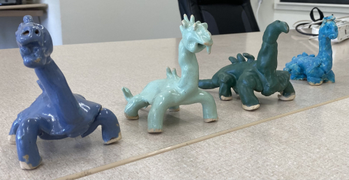 Fired and glazed wetmore clay dinosaurs